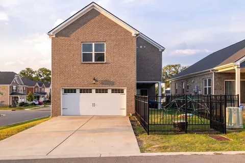 a view of a house with wooden fence