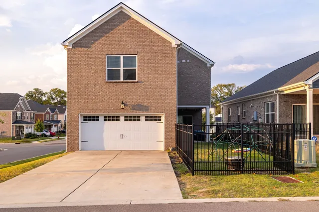 a view of a house with wooden fence