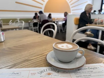 a bathroom with a toilet and a mirror