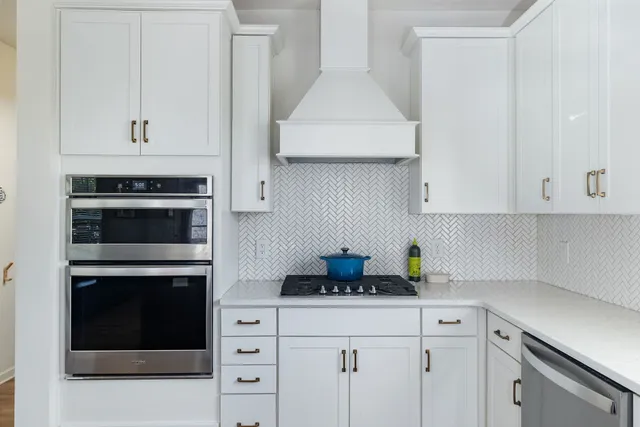 a kitchen with cabinets and appliances