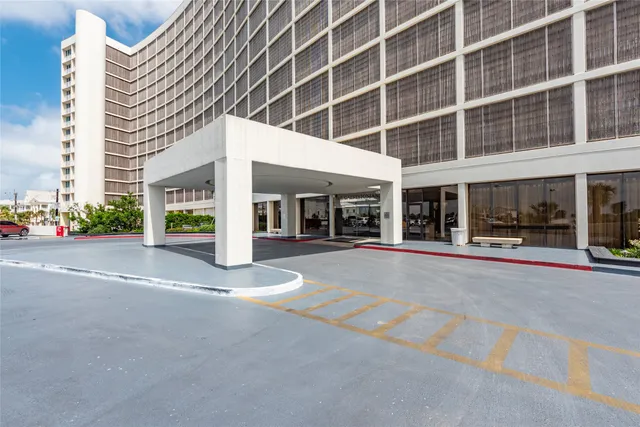 a view of a dining room with furniture and a large window
