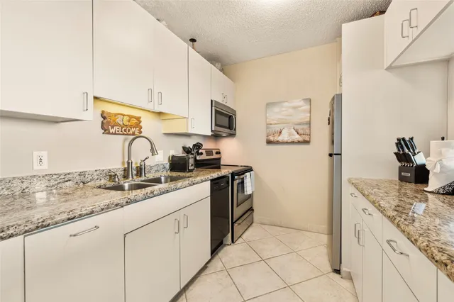 a view of a hallway with wooden floor and a living room