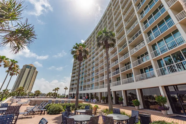 a view of a swimming pool with lawn chairs