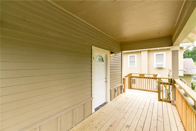 a view of a balcony with wooden floor