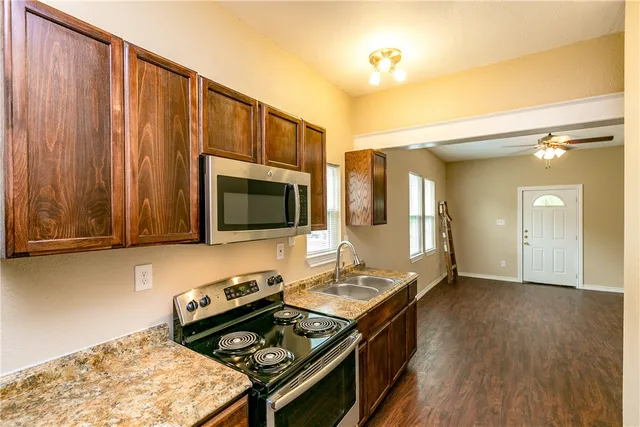 a kitchen with a stove and a microwave