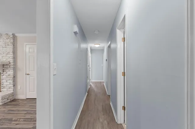 a view of a hallway with wooden floor