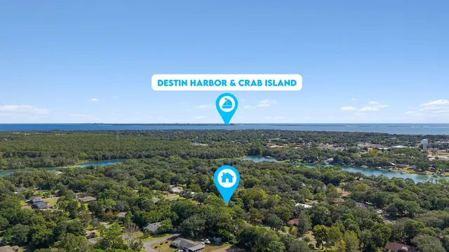 a backyard of a house with large trees and outdoor seating