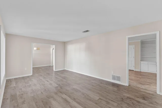 a view of an empty room and wooden floor