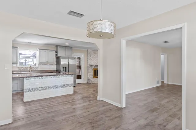 a view of kitchen with refrigerator and window