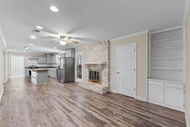 a view of a kitchen with a sink and a fireplace