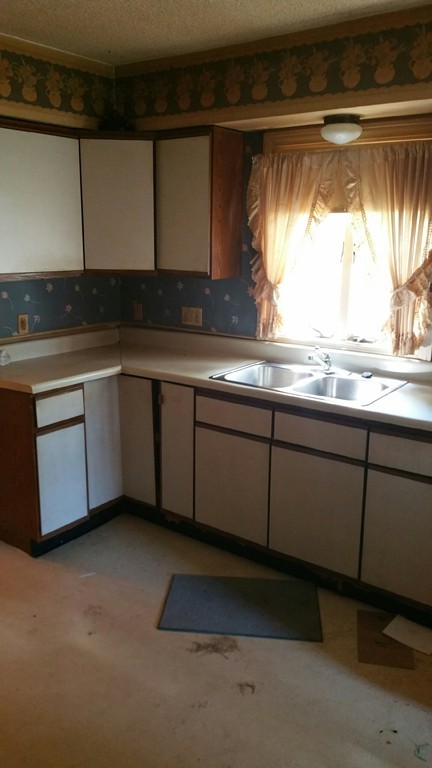 96 Paradise Street Springfield, MA 01129 - Photo 4 of 7 a kitchen with granite countertop sink and cabinets