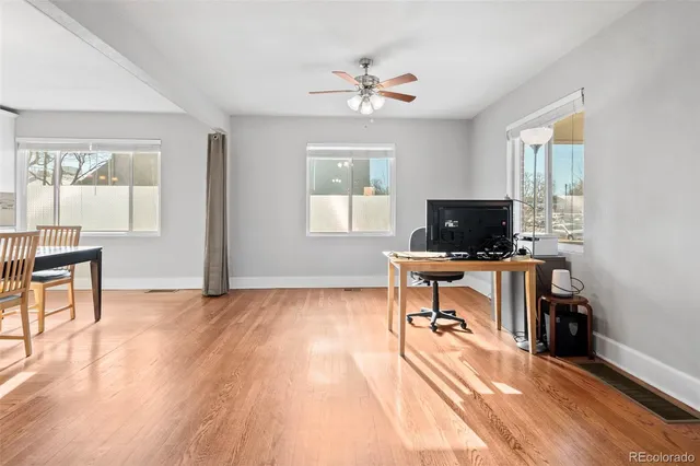 a view of a workspace with furniture and a window