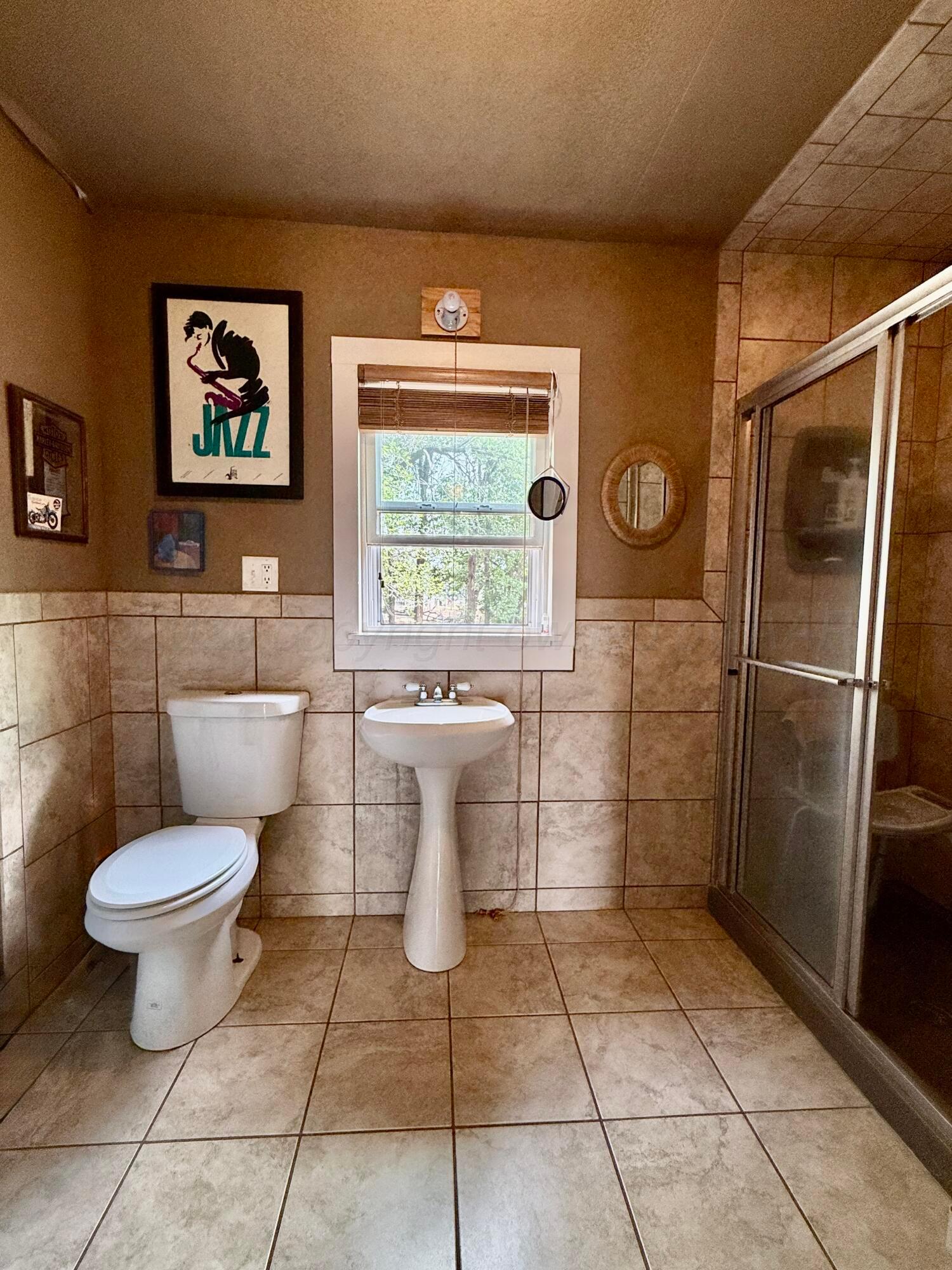 701 Brain Street Borger, TX 79007 - Photo 14 of 18 a bathroom with a toilet and a shower