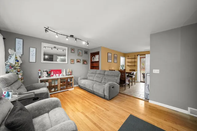 a living room with furniture and kitchen view
