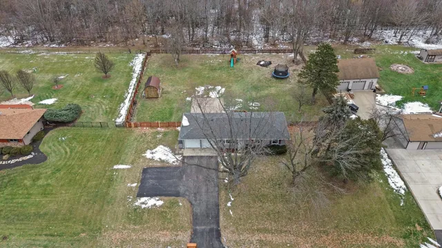 a aerial view of a house with a yard basket ball court and outdoor seating