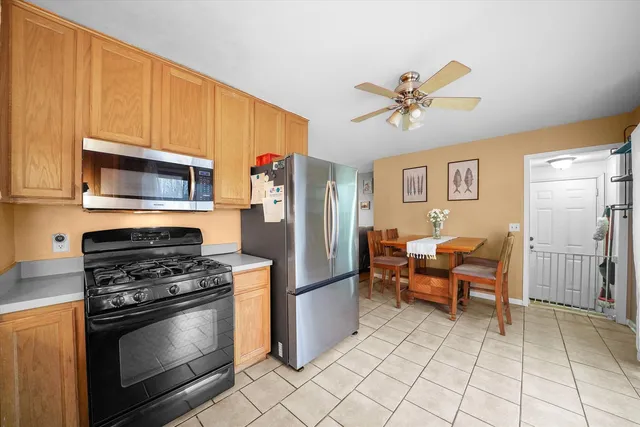 a kitchen with stainless steel appliances granite countertop a refrigerator stove and microwave