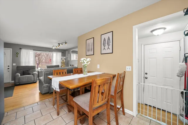 a room with a dining table and chairs