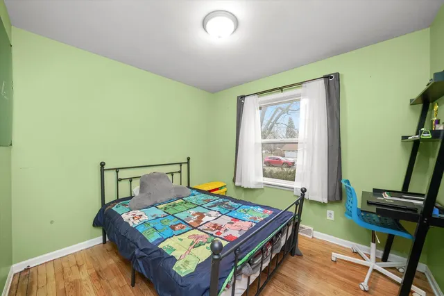 a bedroom with a bed and windows