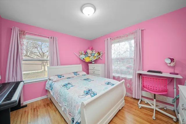 a bedroom with a bed table and a window