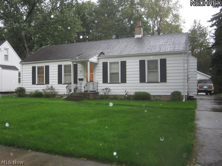 404 Spring Street Struthers, OH 44471 - Photo 1 of 1 View of front of house looking south showing covered front porch, newer asphalt roof and drive leading to 2 1/2 car garage.