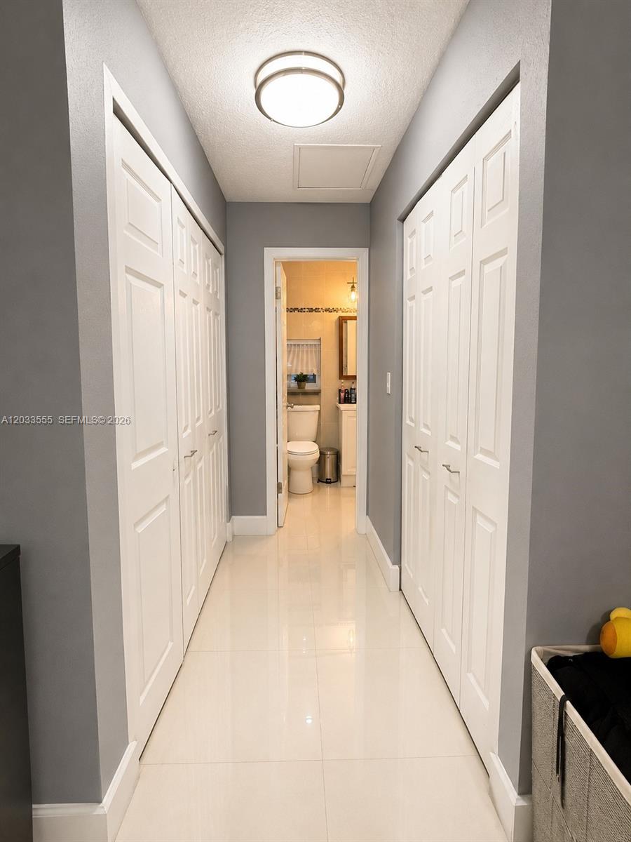12737 Southwest 68th Terrace Miami, FL 33183 - Photo 13 of 32 Walkway view in primary bedroom to connected bathroom