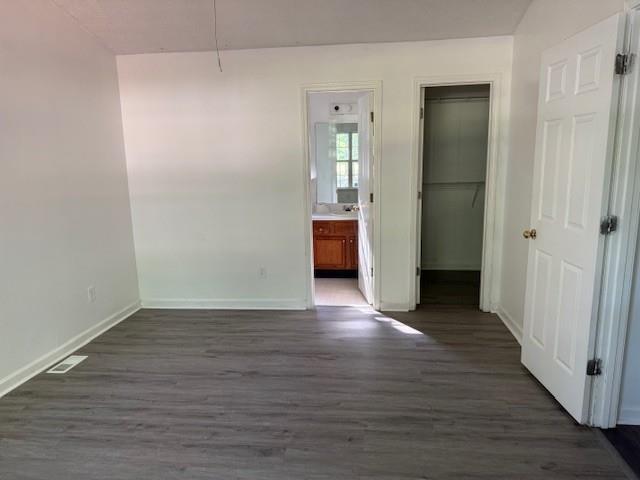 2196 Stenger Road Douglasville, GA 30135 - Photo 10 of 13 a view of an empty room with wooden floor and a bathroom