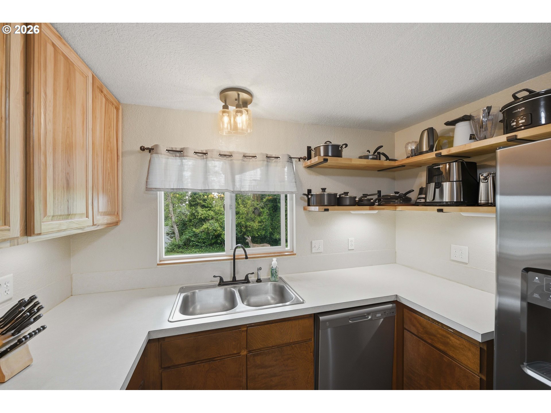 192 North Wood Ridge Road Coquille, OR 97423 - Photo 15 of 42 a kitchen with cabinets a sink and a stove