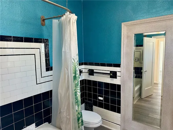 a bathroom with a toilet a sink and shower