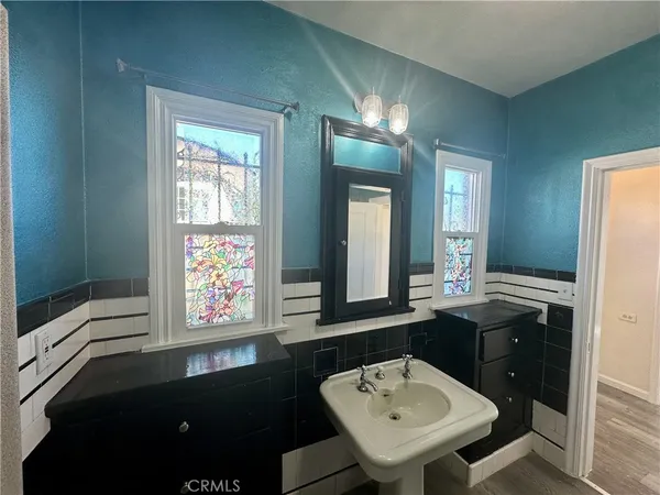 a bathroom with a sink a bathtub and a mirror