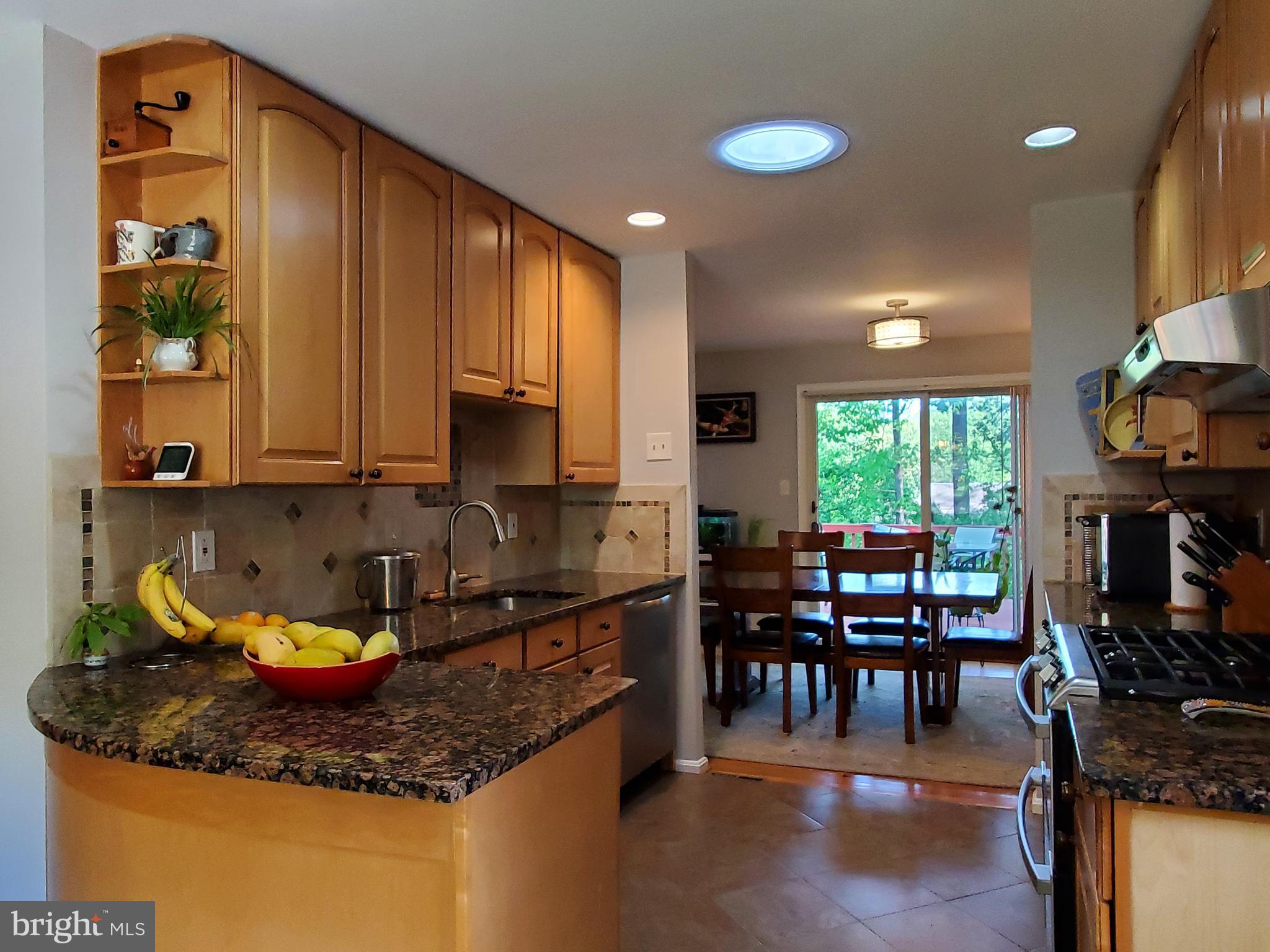 1516 Winding Waye Lane Silver Spring, MD 20902 - Photo 14 of 55 a kitchen with stainless steel appliances granite countertop a sink a stove and a wooden floors