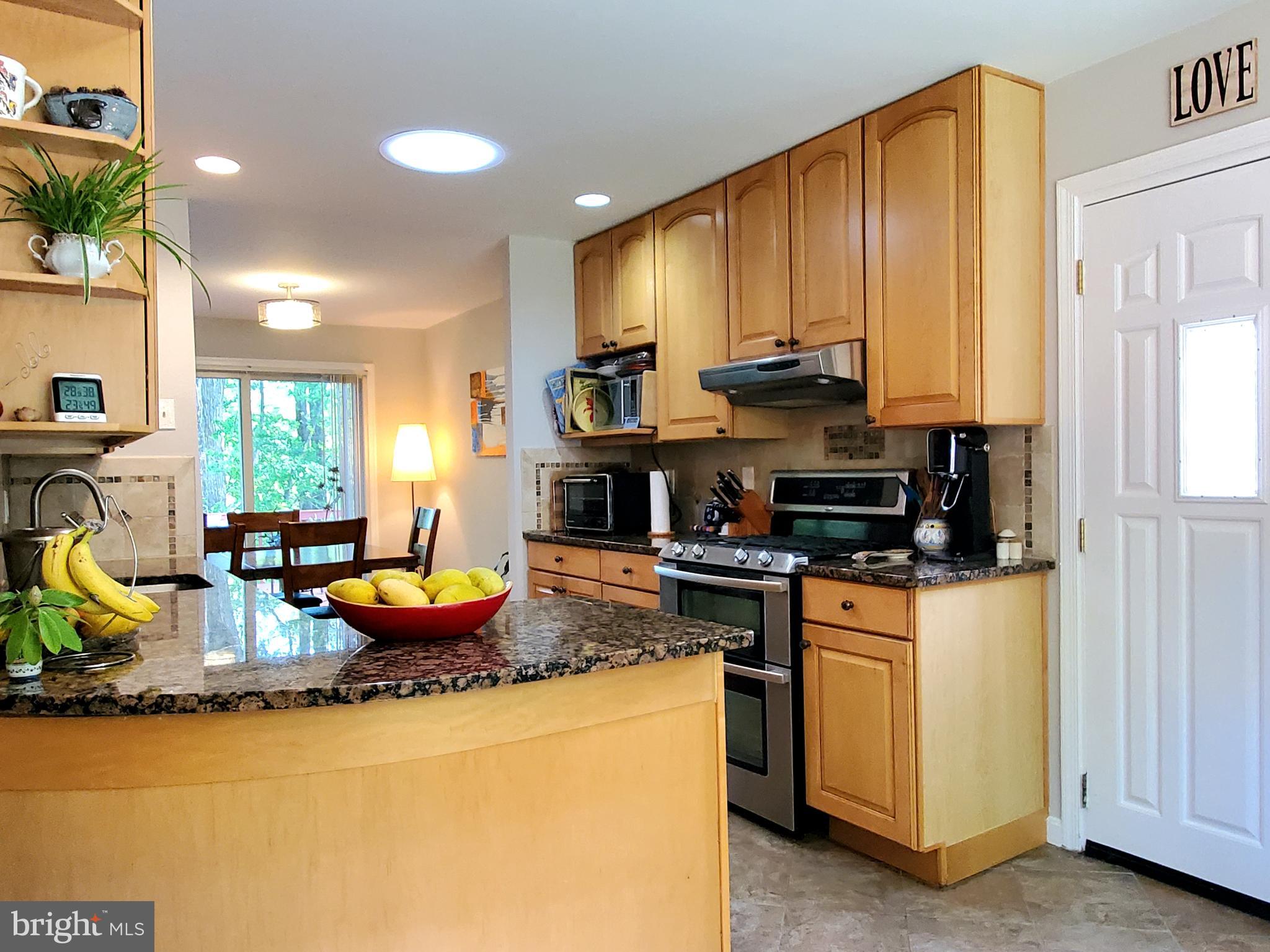 1516 Winding Waye Lane Silver Spring, MD 20902 - Photo 15 of 55 a kitchen with sink a stove and chairs