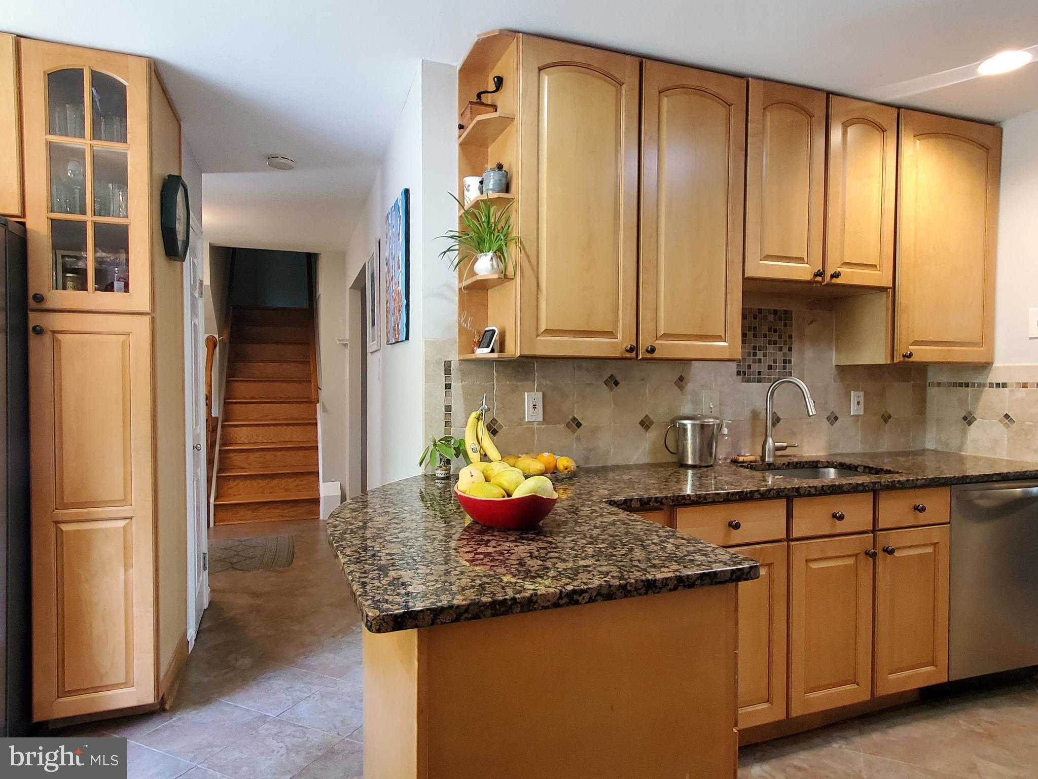 1516 Winding Waye Lane Silver Spring, MD 20902 - Photo 18 of 55 a kitchen with granite countertop cabinets and window