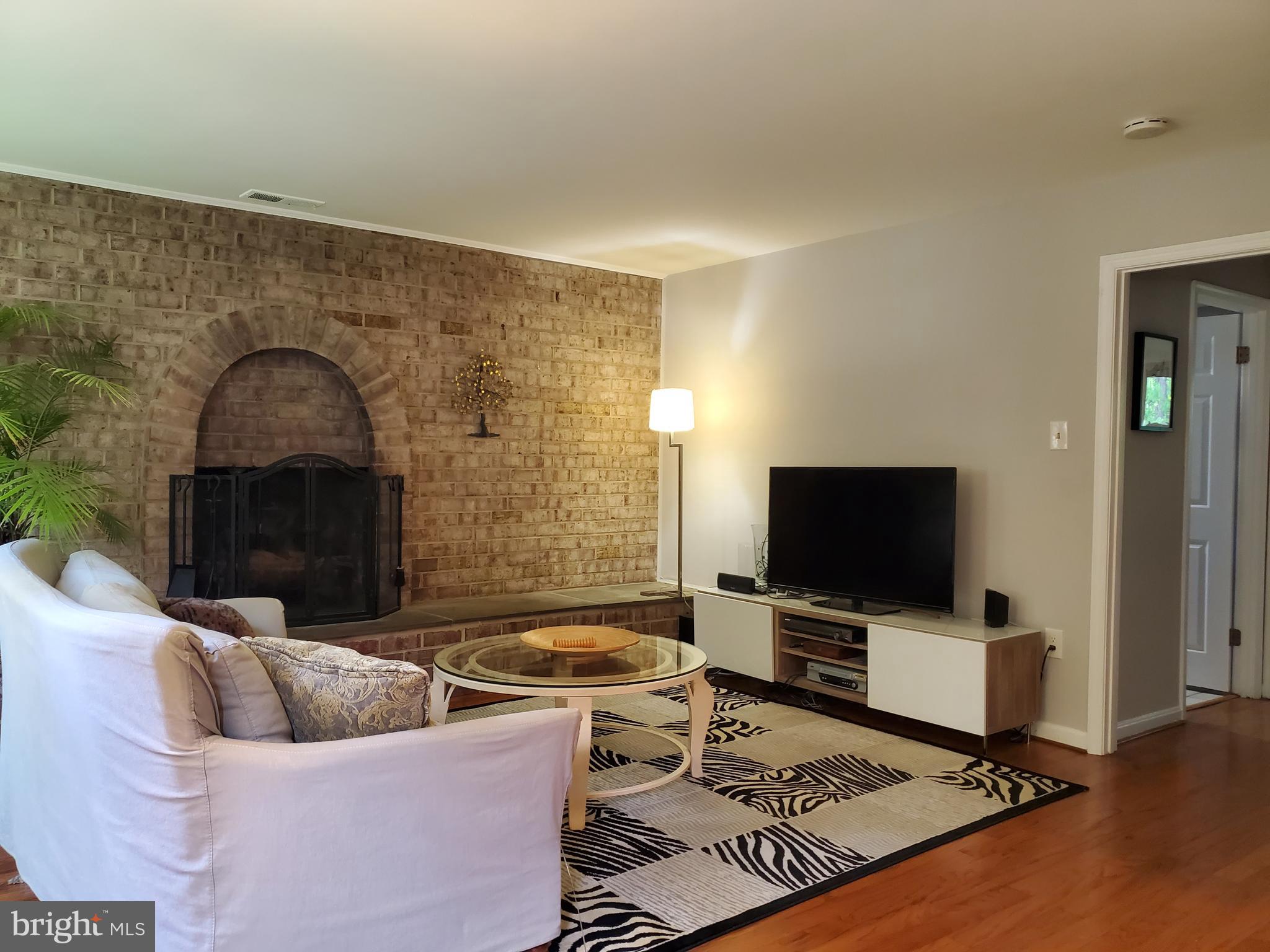 1516 Winding Waye Lane Silver Spring, MD 20902 - Photo 20 of 55 a living room with furniture and a flat screen tv