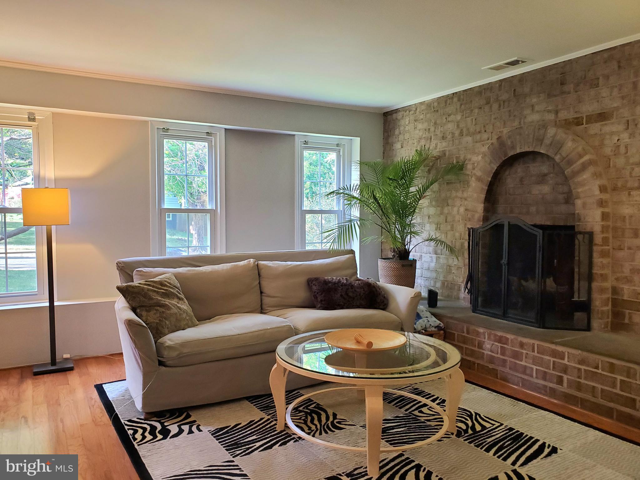 1516 Winding Waye Lane Silver Spring, MD 20902 - Photo 22 of 55 a living room with furniture and a fireplace