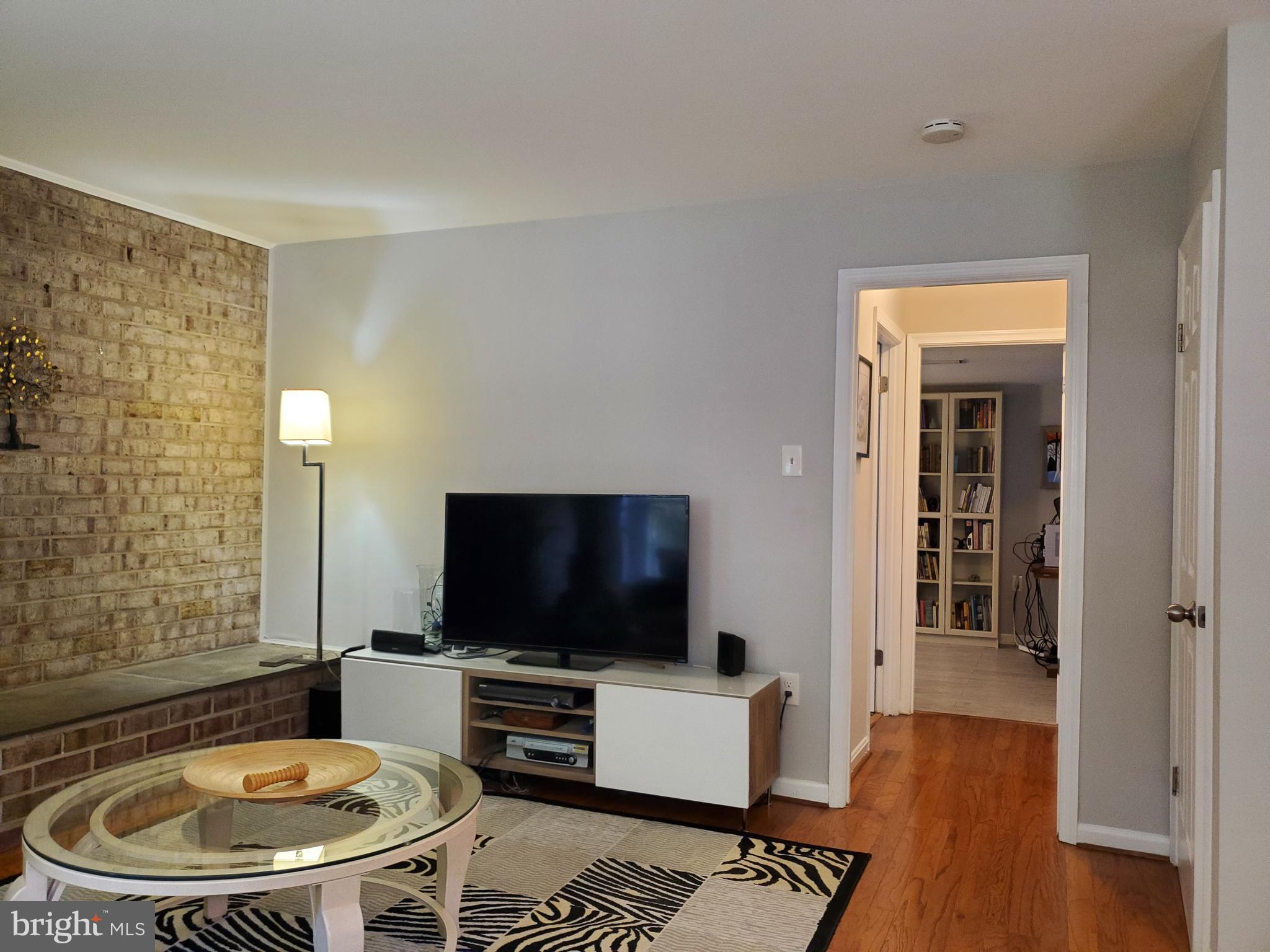 1516 Winding Waye Lane Silver Spring, MD 20902 - Photo 23 of 55 a living room with furniture and a flat screen tv