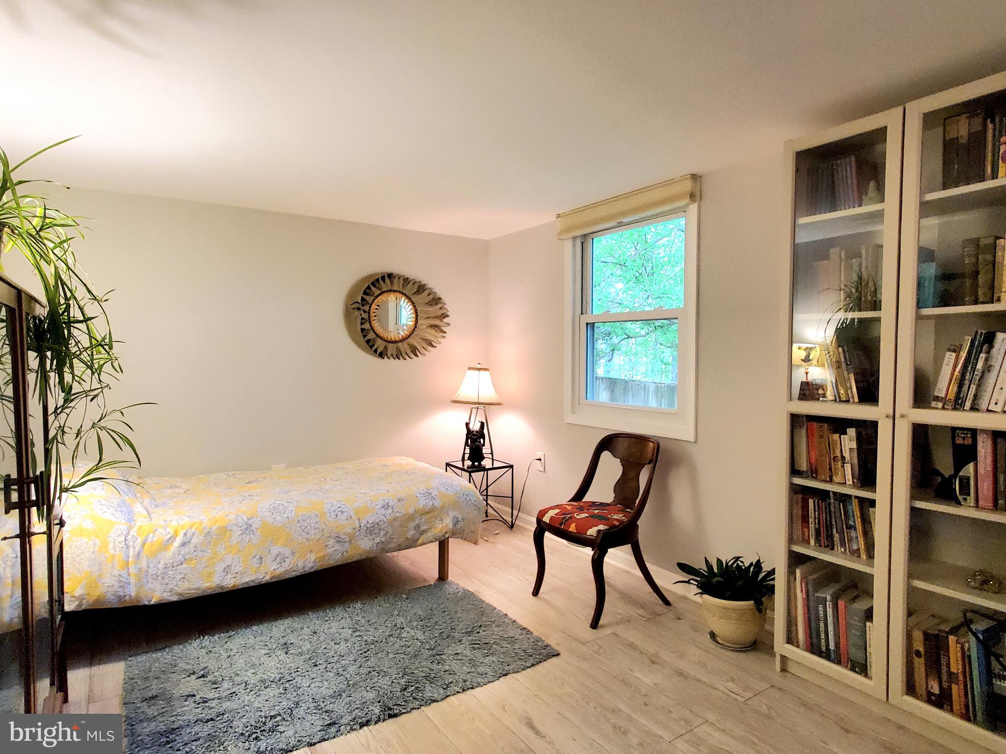 1516 Winding Waye Lane Silver Spring, MD 20902 - Photo 38 of 55 a bedroom with furniture and a book shelf