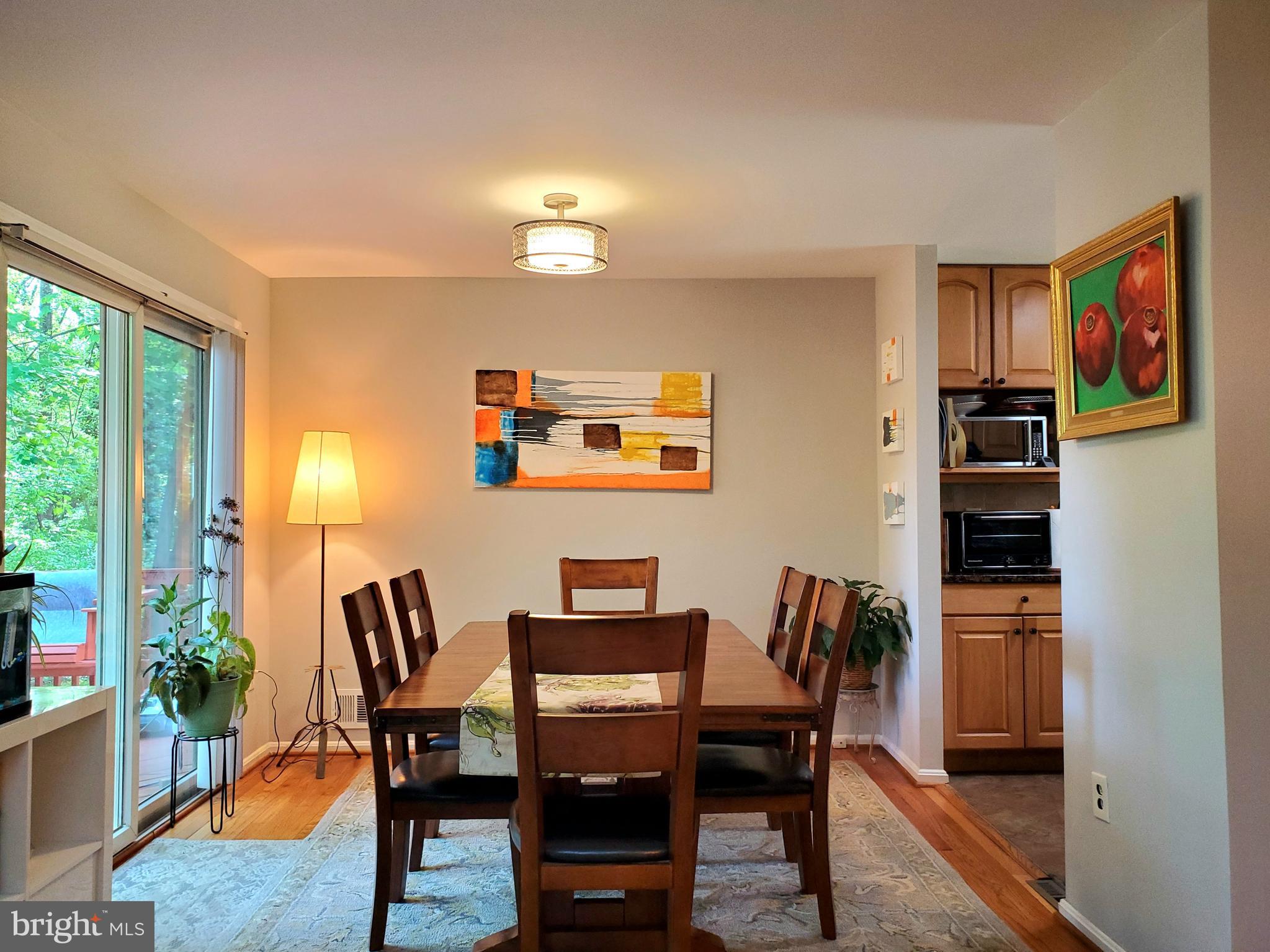 1516 Winding Waye Lane Silver Spring, MD 20902 - Photo 10 of 55 a view of a dining room with furniture and a potted plant