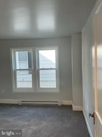 an empty room with cabinet area