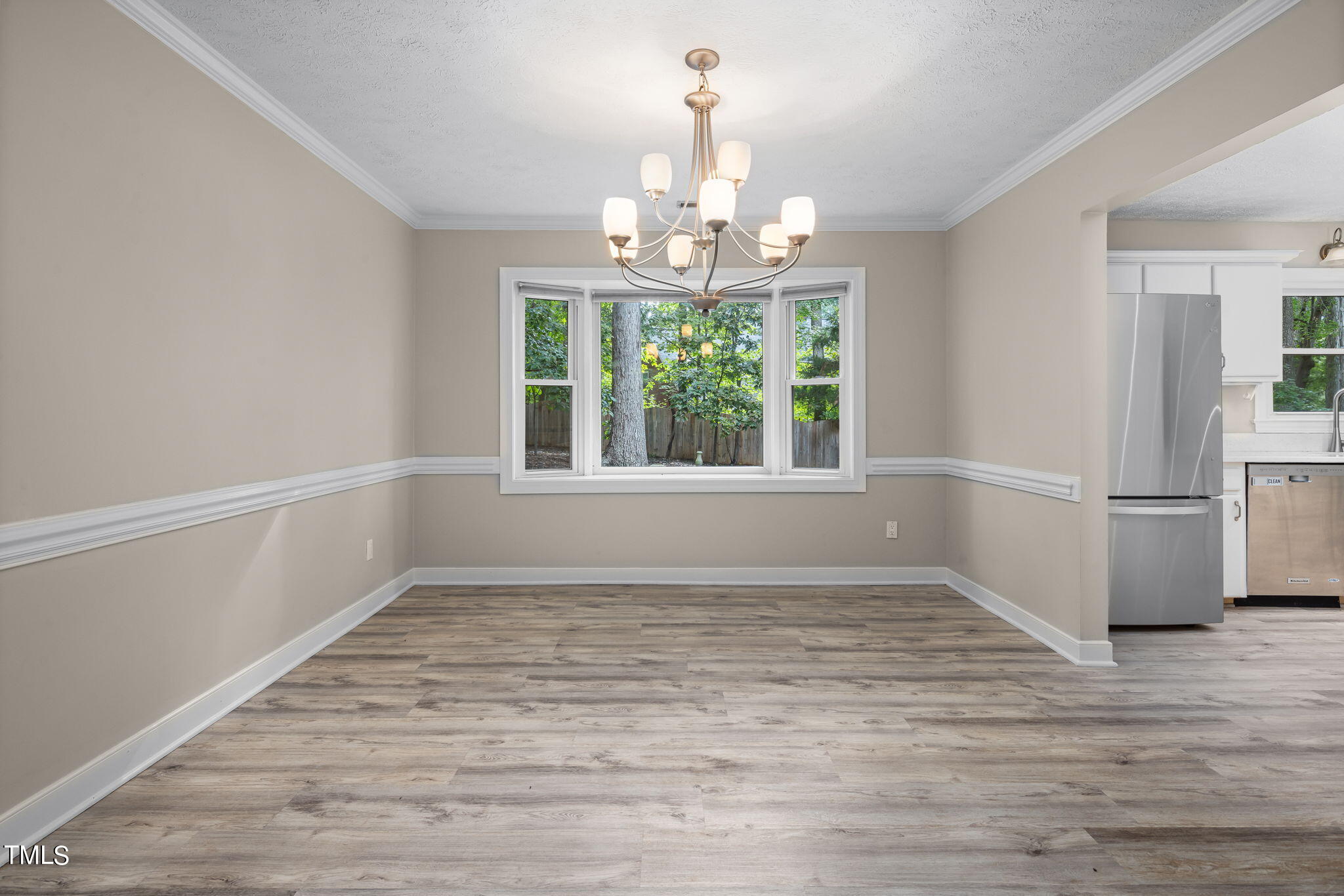 102 Old Bellows Court Raleigh, NC 27607 - Photo 12 of 36 a view of an empty room with wooden floor and a window