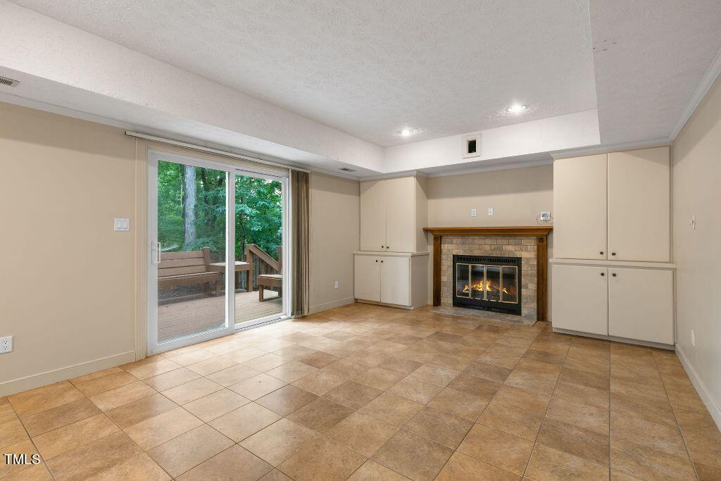 102 Old Bellows Court Raleigh, NC 27607 - Photo 14 of 36 a view of an empty room with a fireplace and a window