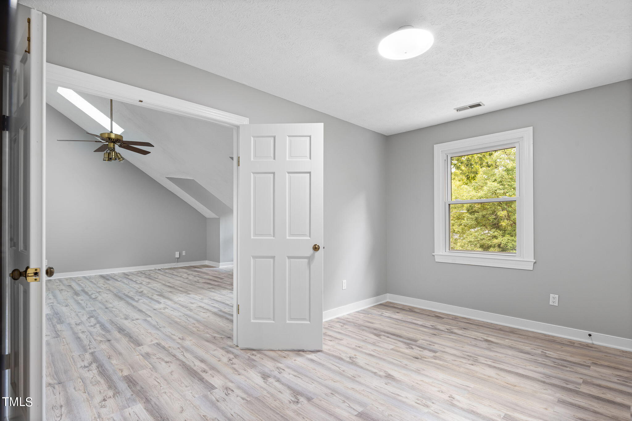 102 Old Bellows Court Raleigh, NC 27607 - Photo 24 of 36 a view of empty room with wooden floor and fan