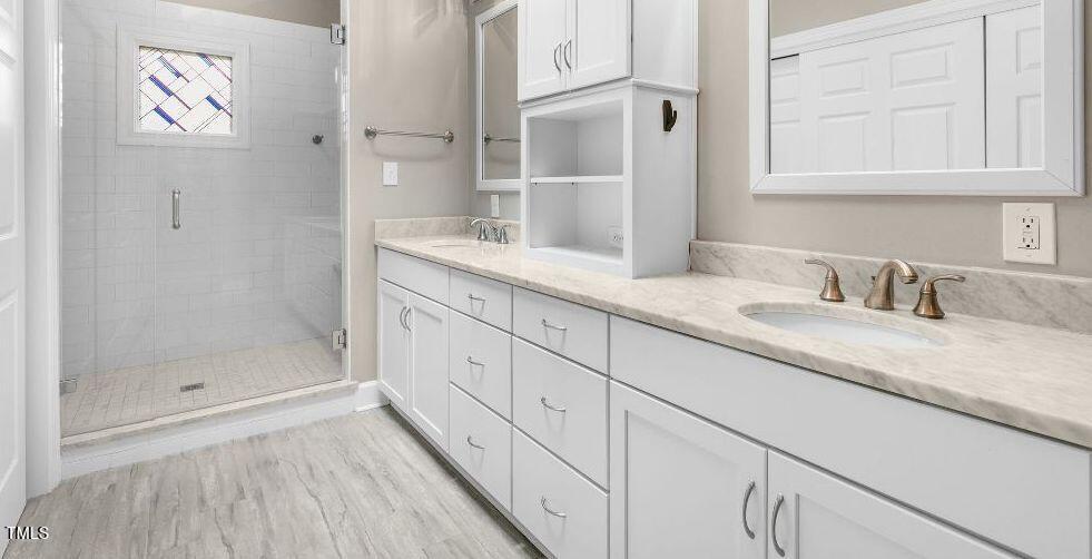 102 Old Bellows Court Raleigh, NC 27607 - Photo 25 of 36 a bathroom with a granite countertop sink mirror and