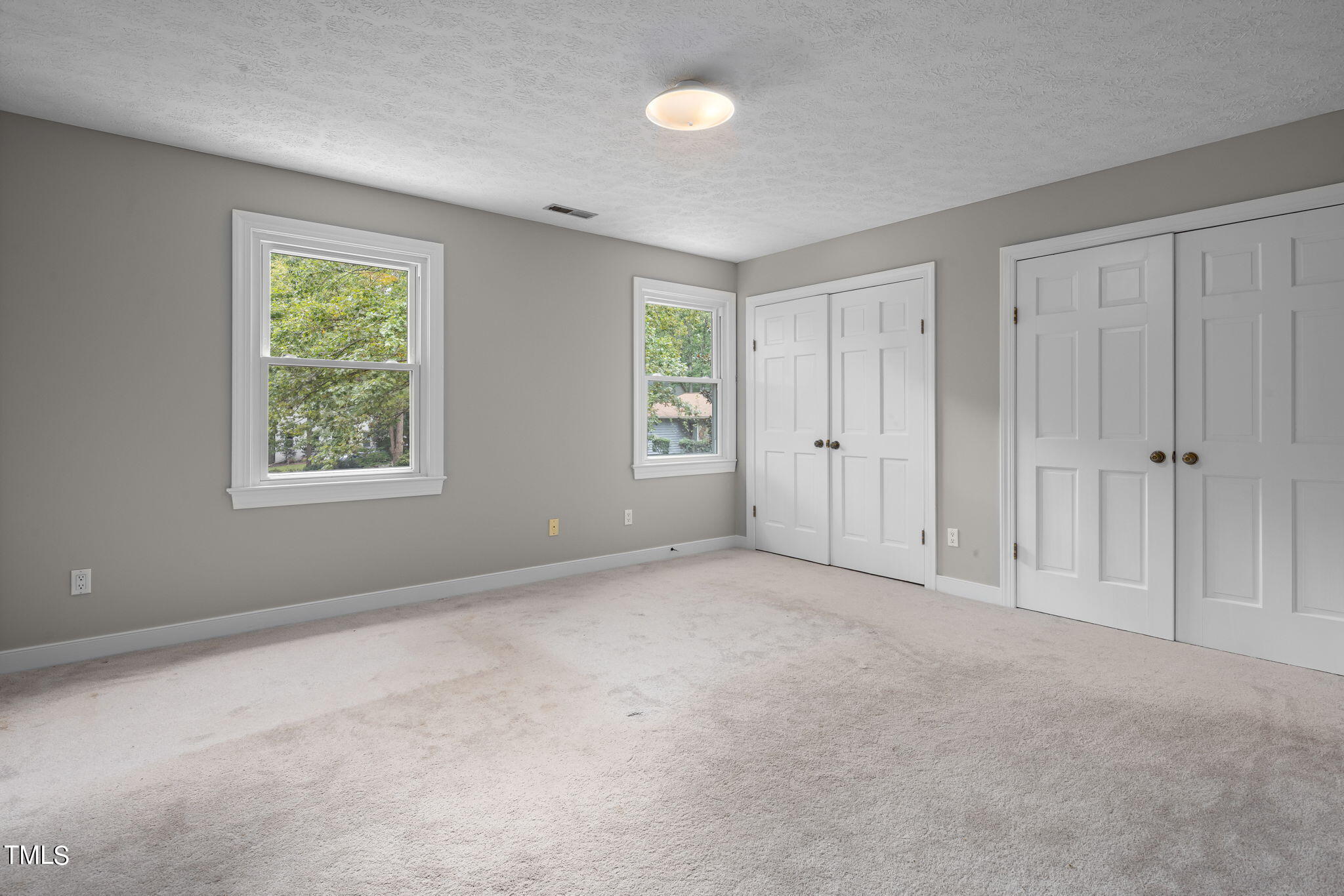 102 Old Bellows Court Raleigh, NC 27607 - Photo 31 of 36 an empty room with windows and closet