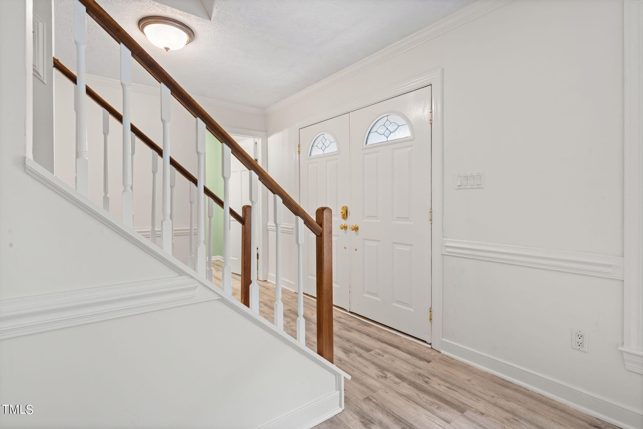 102 Old Bellows Court Raleigh, NC 27607 - Photo 4 of 36 a view of staircase with wooden floor and white walls