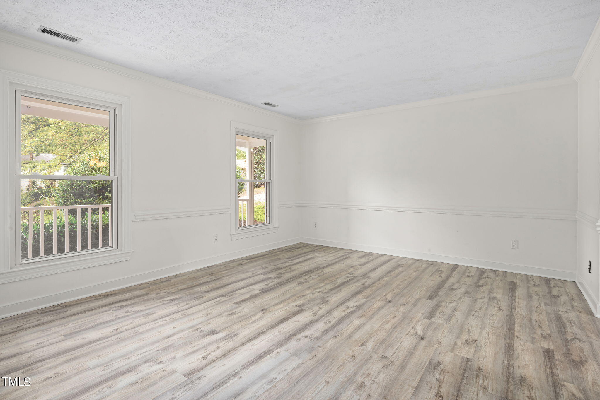102 Old Bellows Court Raleigh, NC 27607 - Photo 6 of 36 a view of empty room with wooden floor and fan