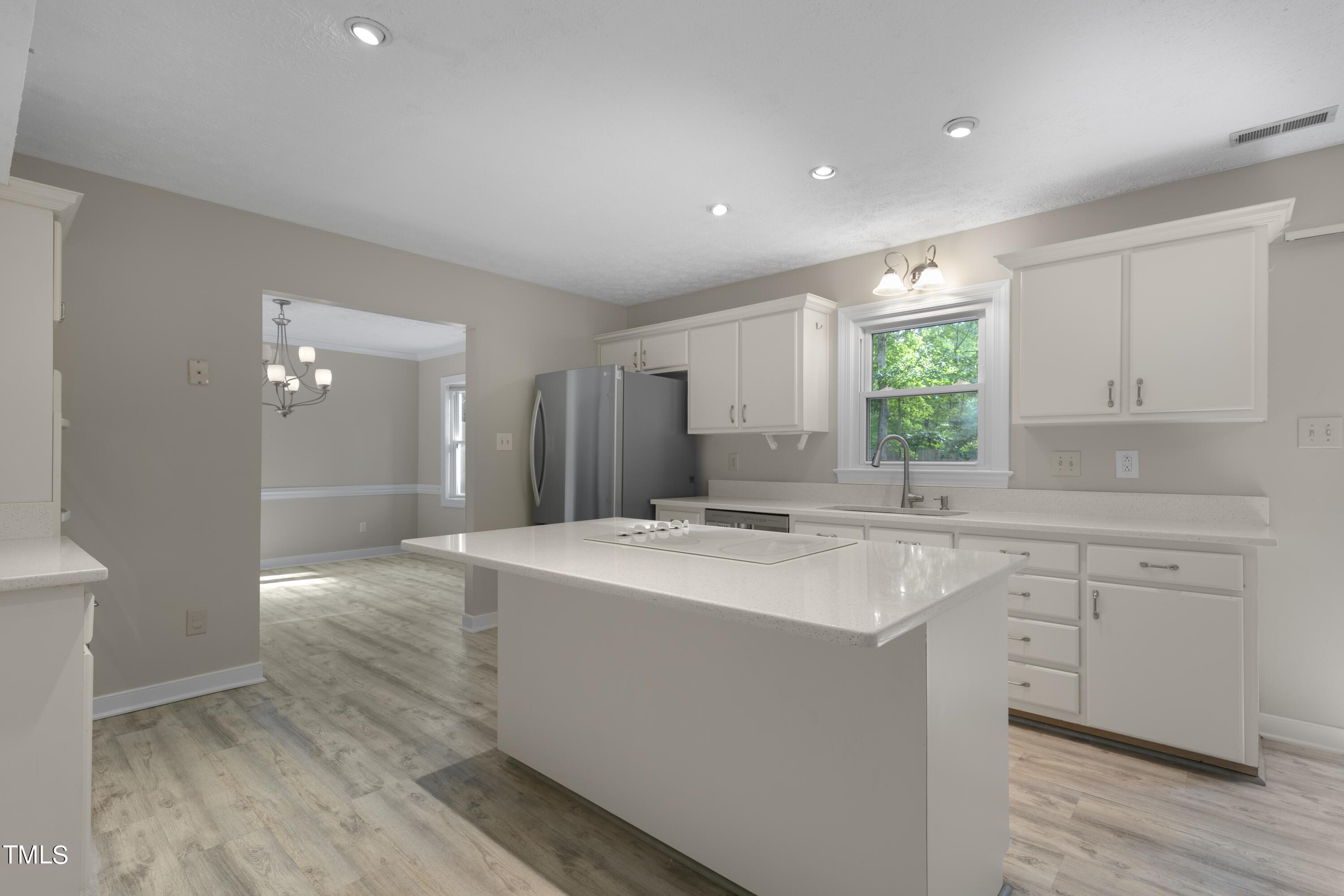 102 Old Bellows Court Raleigh, NC 27607 - Photo 8 of 36 a kitchen with a sink cabinets appliances and a window
