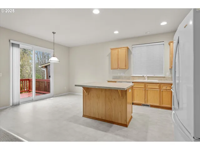 a kitchen with a refrigerator and a sink