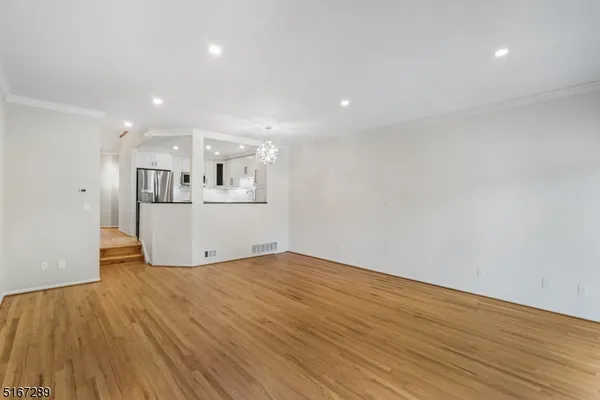 a view of a kitchen with wooden floor and a sink