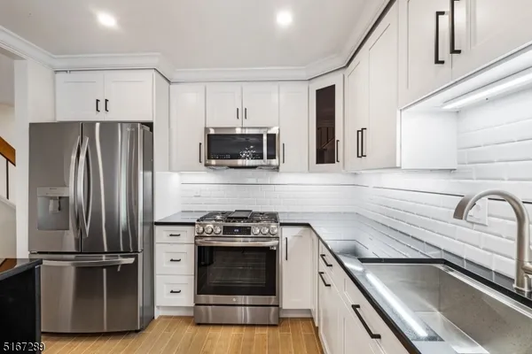 a kitchen with a refrigerator stove and sink