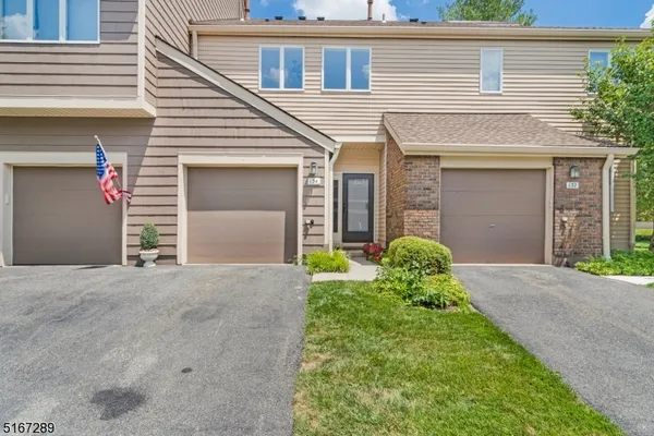 a view of a house with brick walls and a yard